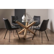 Turin Clear Tempered Glass 4 Seater Dining Table with Light Oak Legs & 4 Fontana Dark Grey Suede Fabric Chairs with Grey Hand Brushing on Black Powder Coated Legs