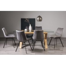 Turin Clear Tempered Glass 6 Seater Dining Table with Light Oak Legs & 6 Fontana Grey Velvet Fabric Chairs with Grey Hand Brushing on Black Powder Coated Legs