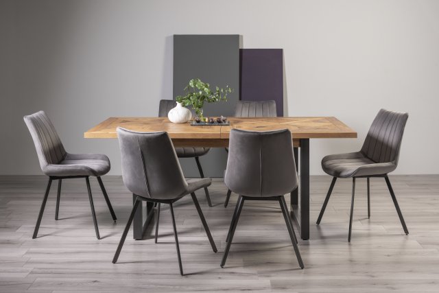 Signature Collection Indus Rustic Oak 6-8 Seater Dining Table with Peppercorn Legs & 6 Fontana Grey Velvet Fabric Chairs with Grey Hand Brushing on Black Powder Coated Legs