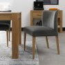 Bentley Designs Turin Light Oak 4 Seater Glass Circular Dining Set & 4 Low Back Upholstered Chairs in Gun Metal Velvet Fabric