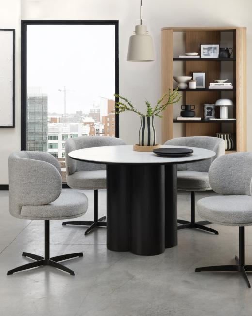 The Warren dining table pairs a smooth white sintered stone top with a bold black oak base, effortles...
